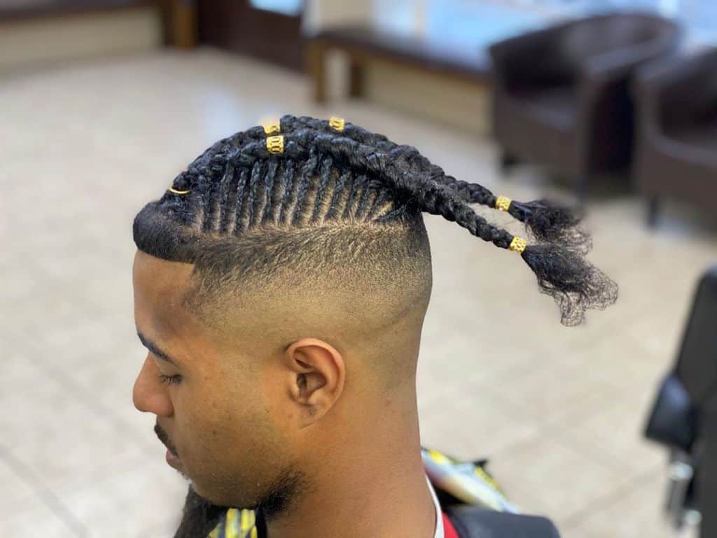 A Braided Mohawk Featuring Two Long Braids On Top Spanning From The Front To The Back And Short Braids On The Sides Cascading To The Ears
