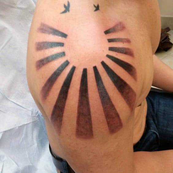 Black Ink Faded Rising Sun Mens Shoulder Tattoo Designs