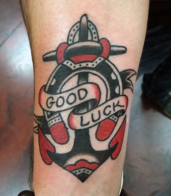 Guy With Traditional Horseshoe Good Luck Banner Forearm Tattoo