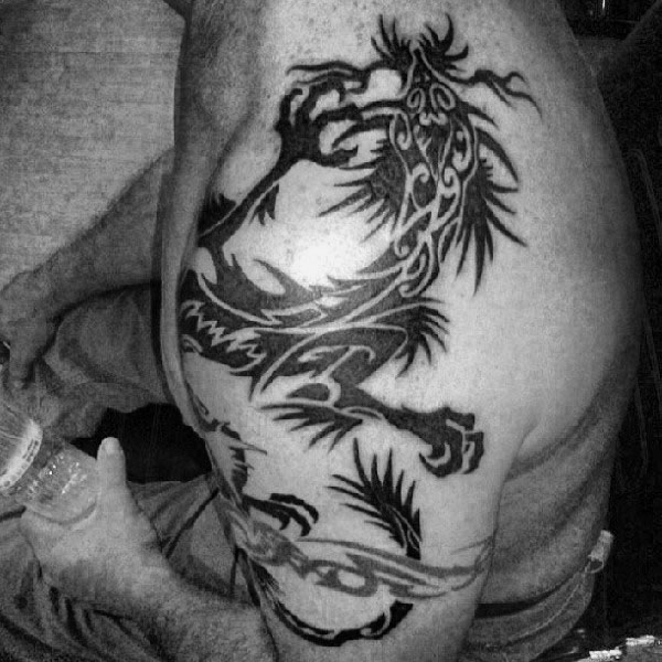 Man With Tribal Dragon Tattoos Arm