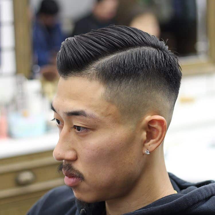 A haircut with front-swept manes and medium fade sides and back