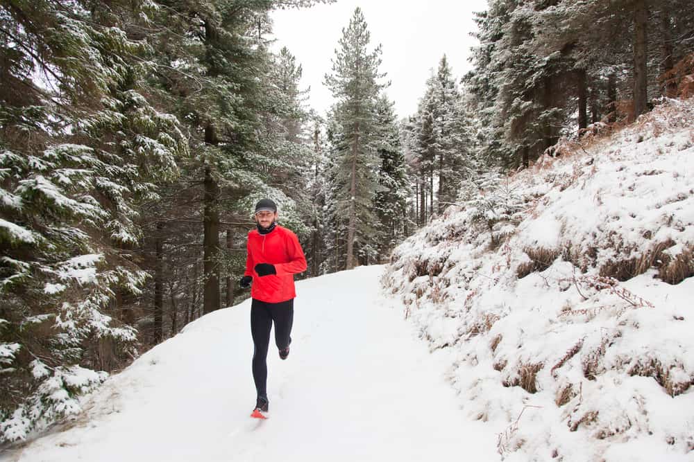 athlete running on trail during winter 